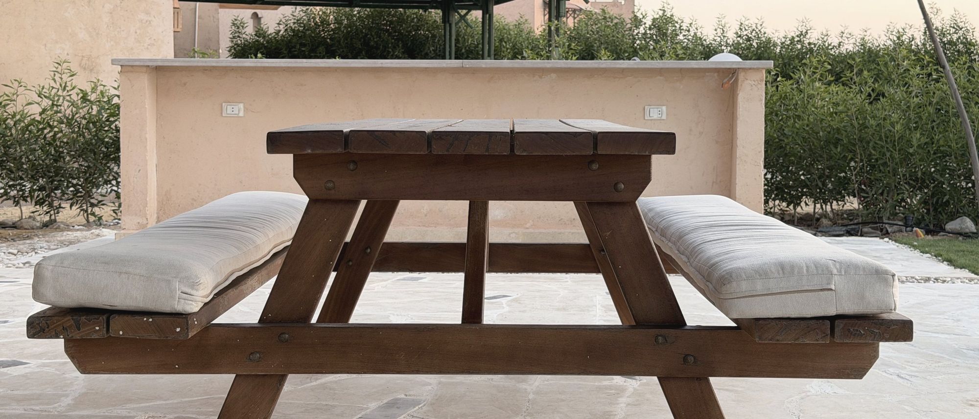 The outdoor table and benches in the garden